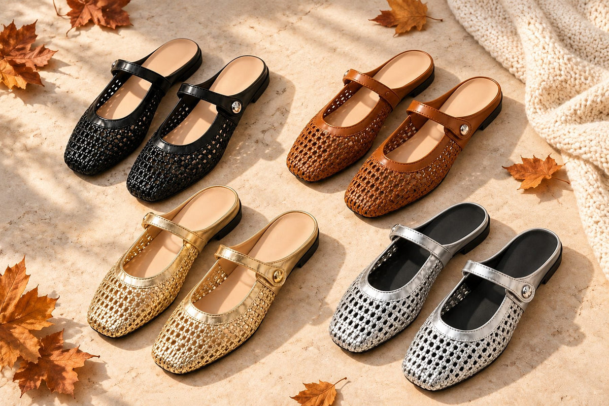 Four pairs of square-toe woven leather Mary Jane mule flats in black, brown, gold and silver laid out on pale stone