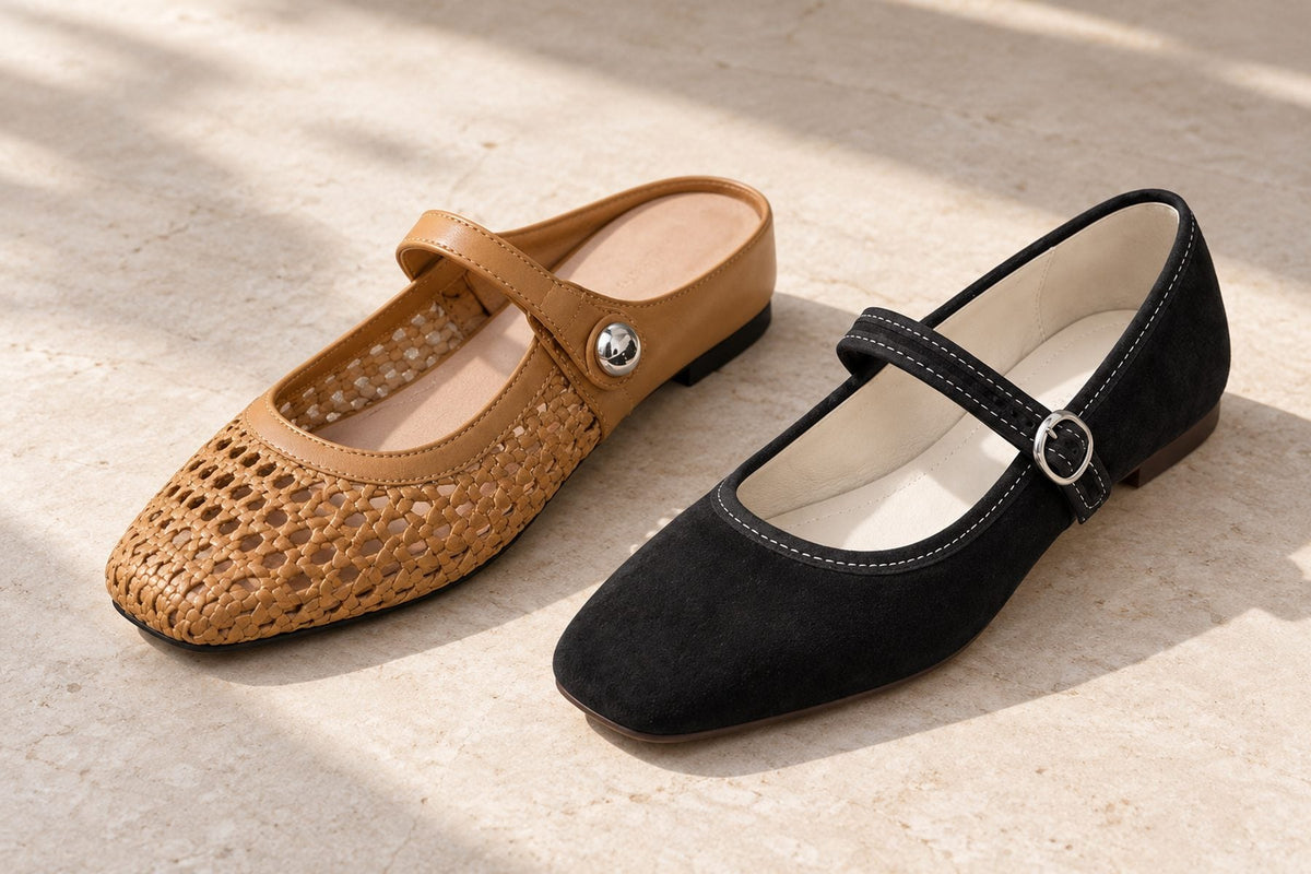 Camel woven Mary Jane mule flats beside black closed-back Mary Jane flats on a pale stone floor in daylight
